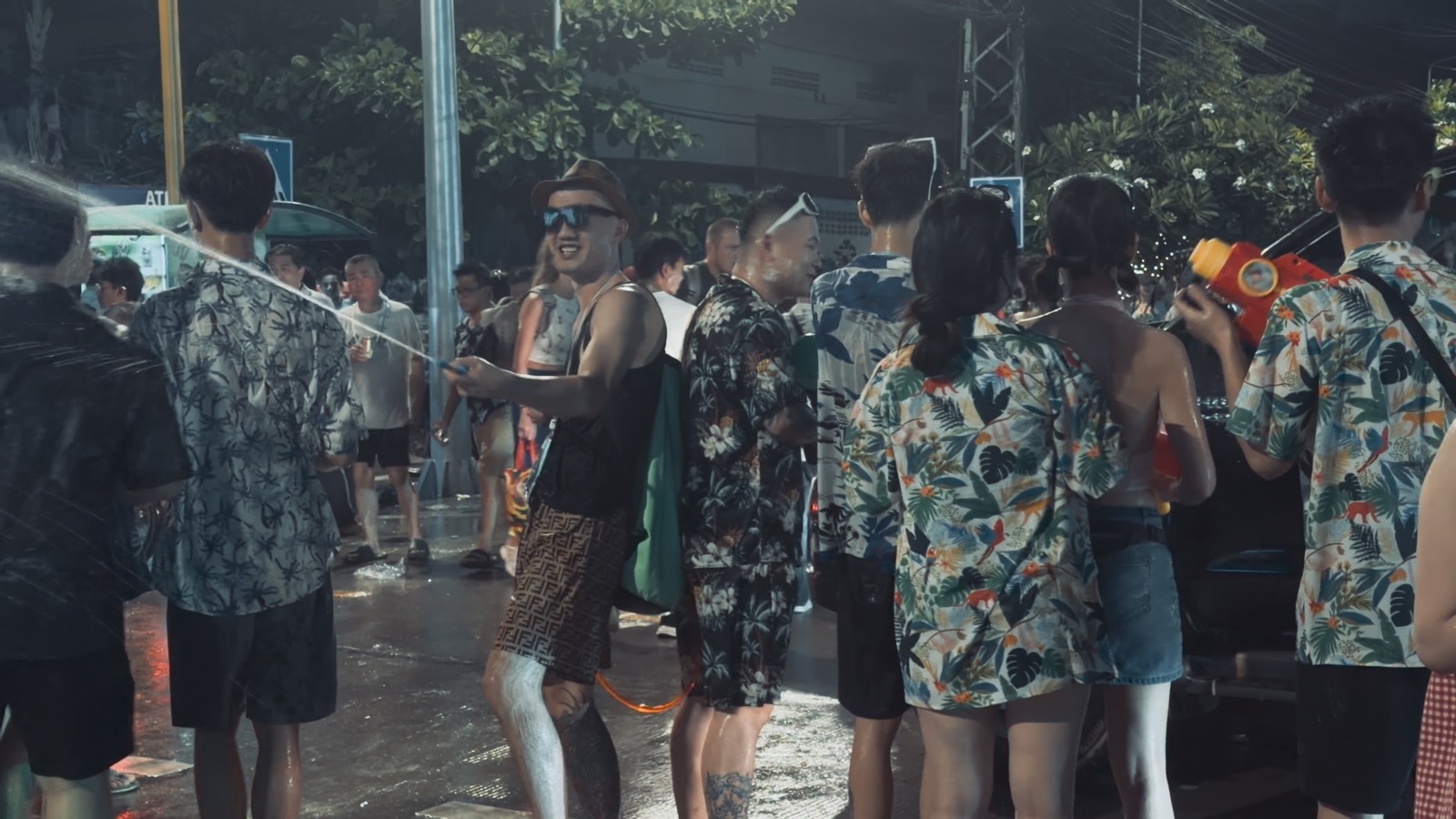 A Songkran street water fight in Thailand, crowds spraying each other with water guns